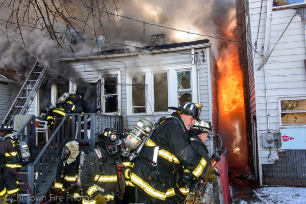 Chicago firefighters battle fire in a house
