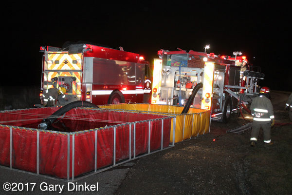 fire engines drafting from portable tanks at night