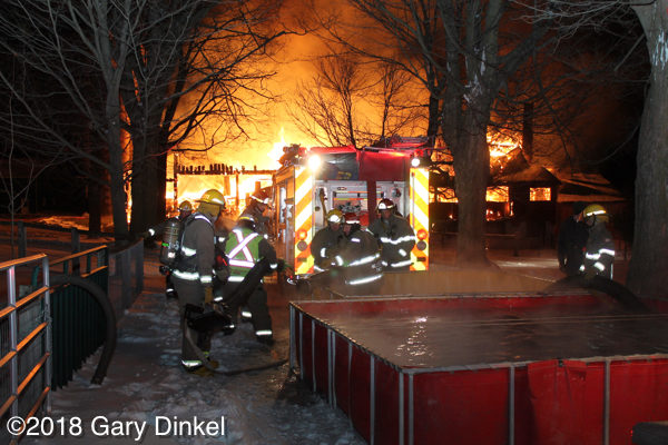 firefighters prepare to draft water at a fire 