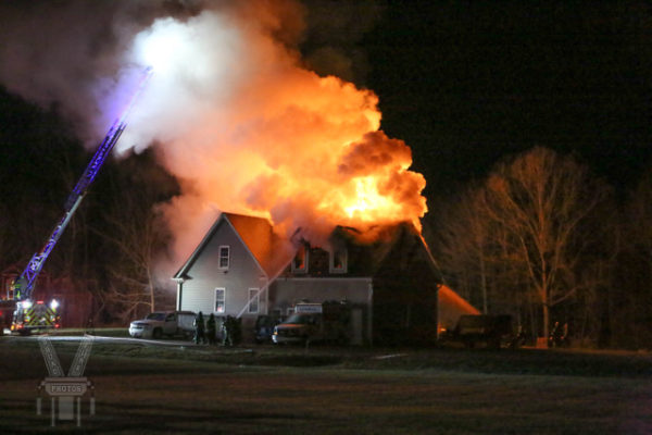 heavy flames and smoke from house fire at night