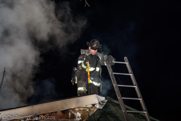 Firefighter on the roof at night