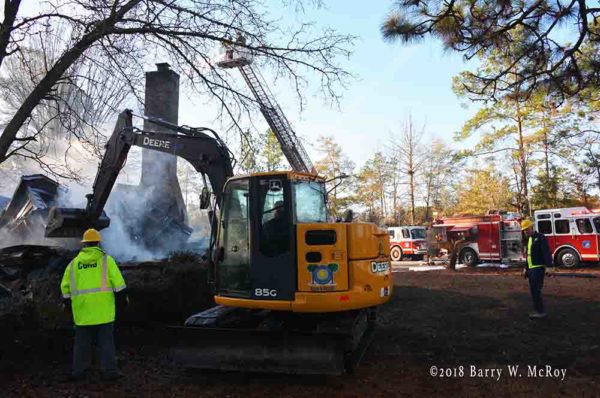 excavator works after house fire