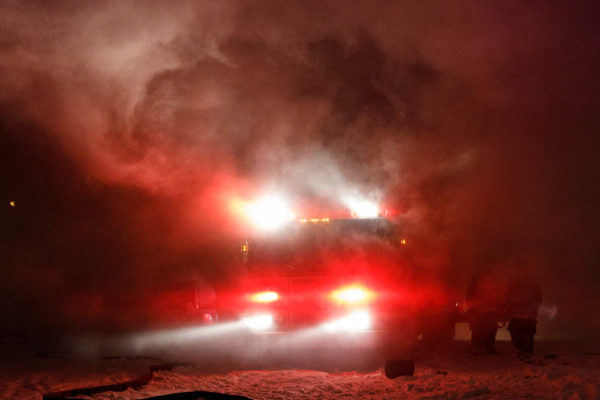 fire truck with lights in smoke at night