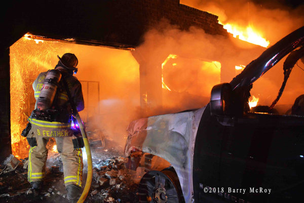 Firefighter battles house fire at night