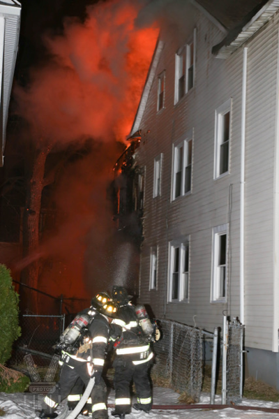Firefighters battle building fire at night