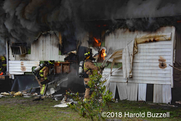 Firefighters overhaul mobile home fire
