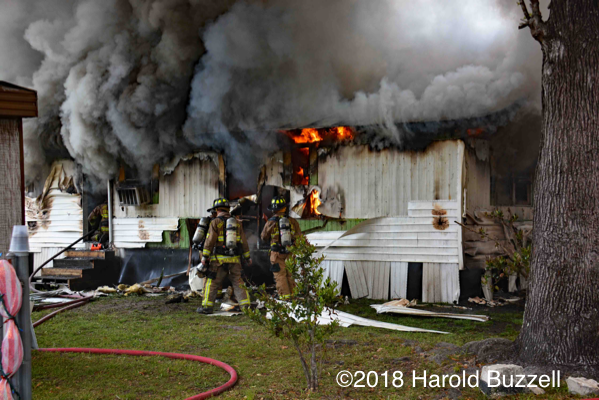 Firefighters overhaul mobile home fire
