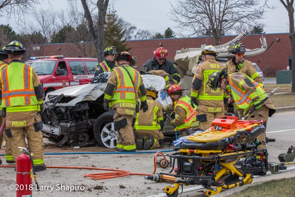 Firefighters free driver trapped in car Stryker power load cot