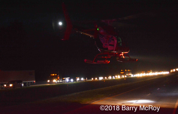 C.A.R.E Medical helicopter landing on the highway