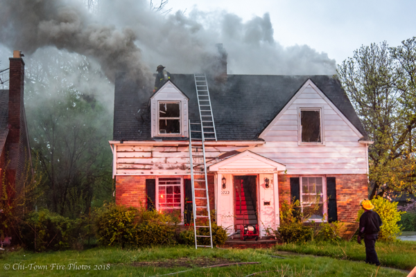 Firefighters vents roof during house fire with lots of smoke