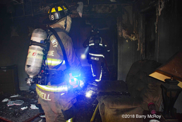 Firefighters inside house after a fire