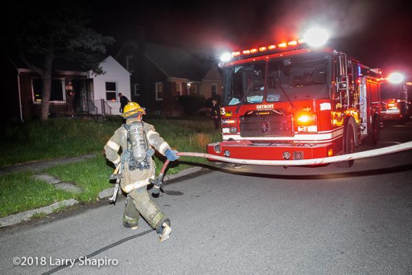 Detroit Firefighter pulling a red line