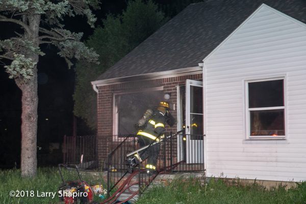 Detroit Firefighter entering a house on fire