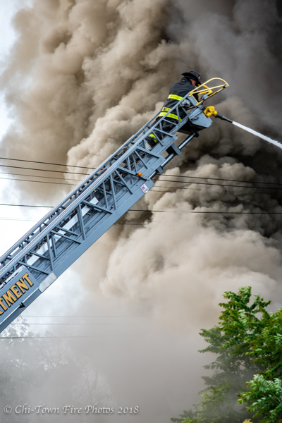 Detroit Firefighter at aerial ladder tip with heavy smoke