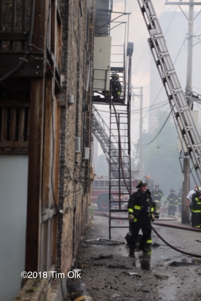 Firefighter in alley with fire escape