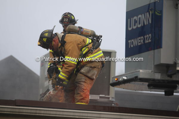 Firefighters vent roof during a fire