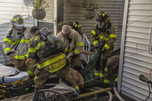 Firefighters crawl from basement after rescuing a victim