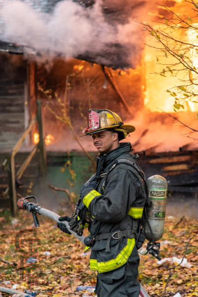 Detroit Firefighters monitor a vacant dwelling engulfed by fire