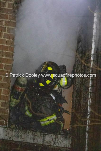 Firefighter at fire scene with smoke