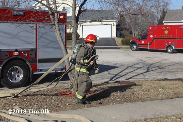 Firefighter pulls hose