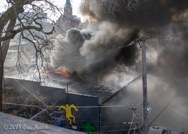 fire burns through a barrel truss roof warehouse