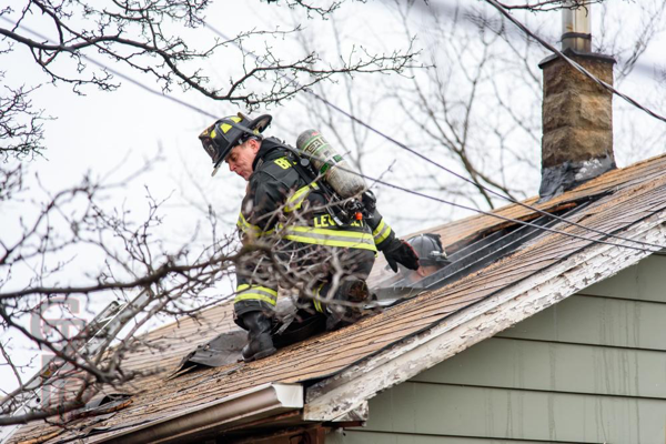 Firefighter on house roof