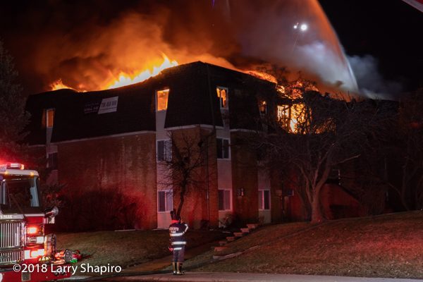 apartment building with Mansard roof on fire