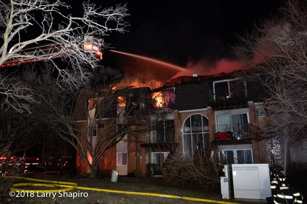 apartment building with Mansard roof on fire