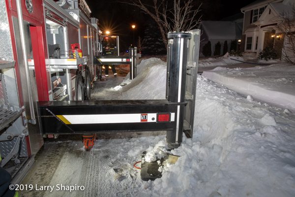 fire truck outriggers in snow bank