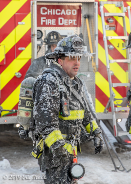 Firefighter covered with ice after battling a fire