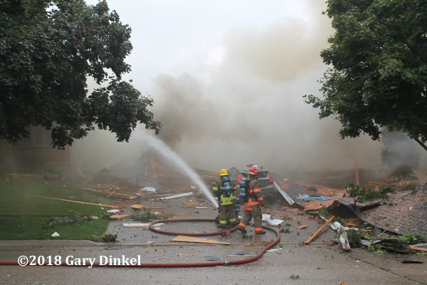 Firefighters at the scene of a fatal house explosion