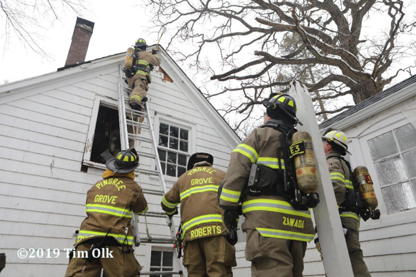 Firefighters overhaul after a house fire