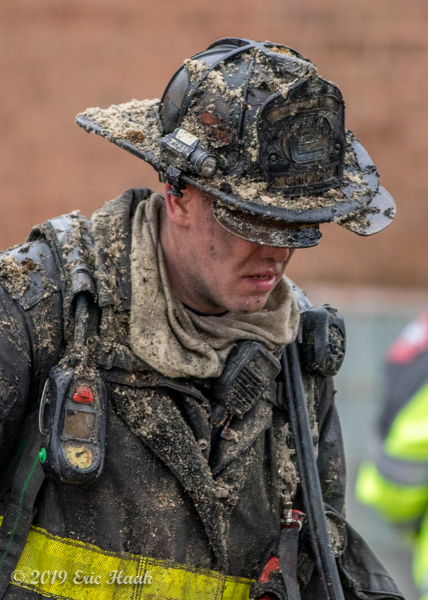 Chicago FD Firefighter covered with insulation after overhauling a fire