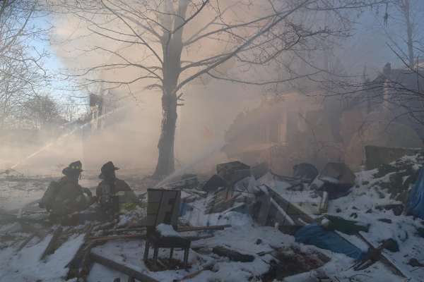 Firefighters battle house fire in the snow