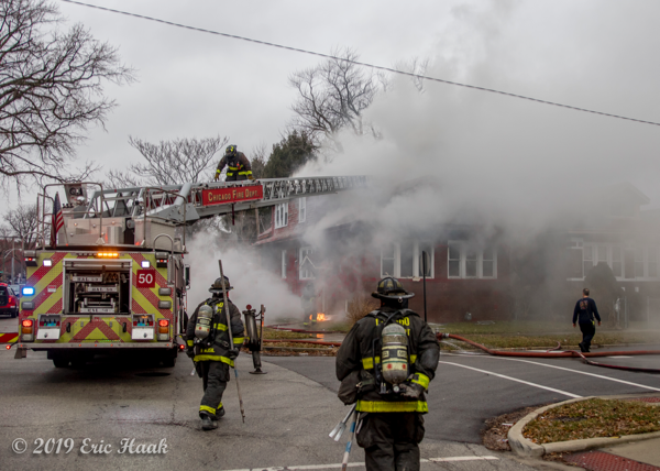 Firefighters battle a smokey house fire