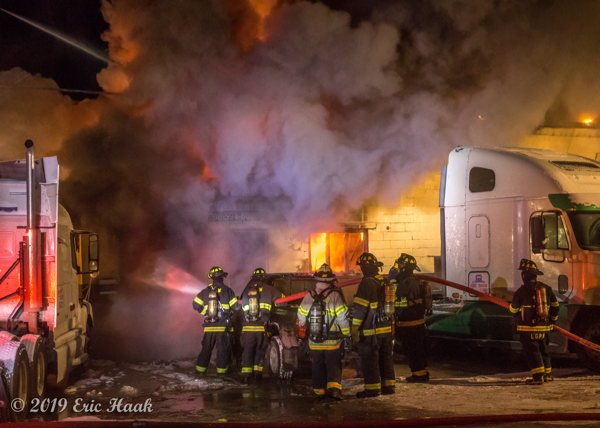 Firefighters battle frigid temperatures and huge fire at truck repair shop
