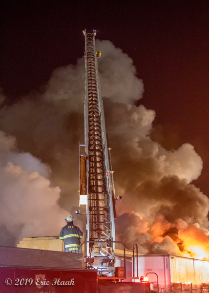 aerial ladder fire truck battles huge fire at night