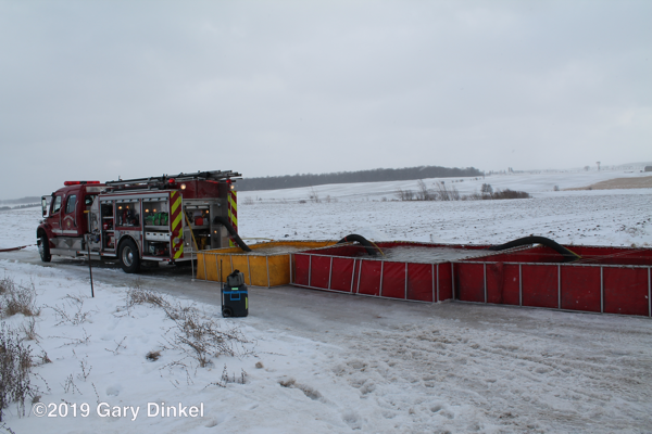 rural water supply at fire scene with multiple portable tanks
