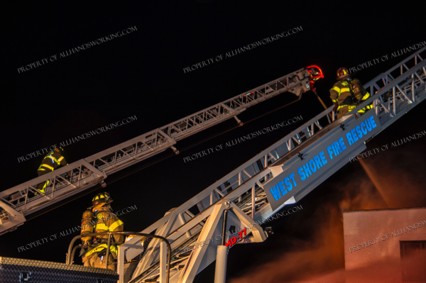 two aerial ladders up at night fire scene
