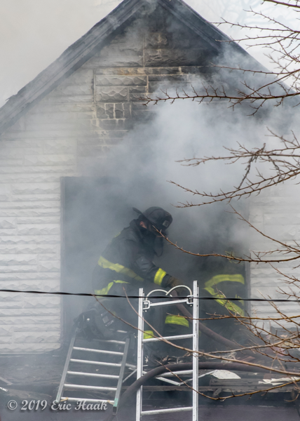 Firefighters overhaul fire with lots of smoke