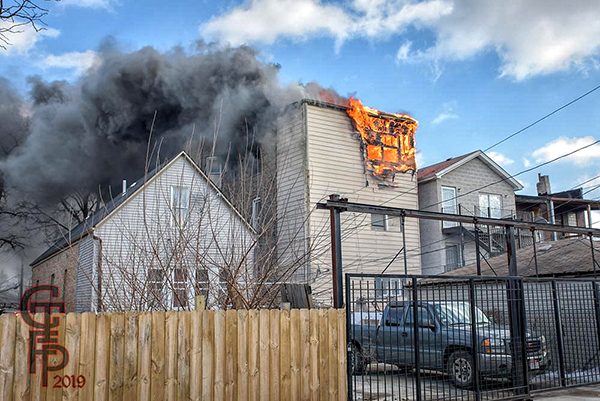 flames burn through third floor of house