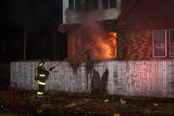 Detroit firefighter with hose line at fire scene