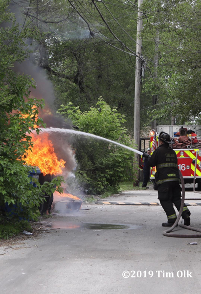 Firefighter attacks alley garage fire with a hose line