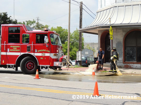 Firefighters flush hydrant at fire scene