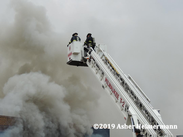 Firefighters in Pierce tower ladder battle fire