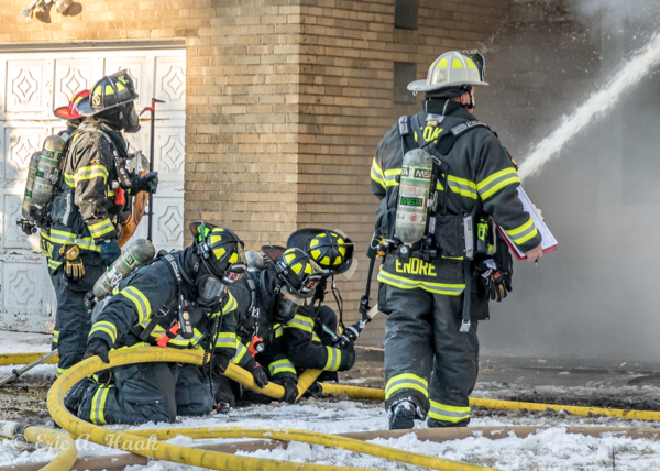Firefighters with big hose line