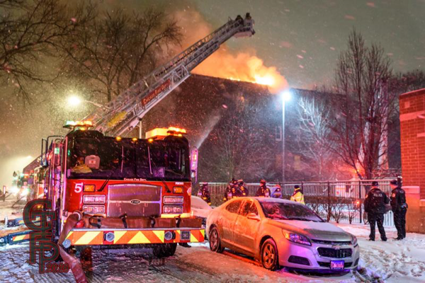 Chicago Firefighters battle fire in snow storm
