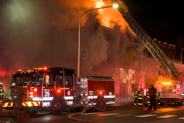 heavy fire engulfs building at night