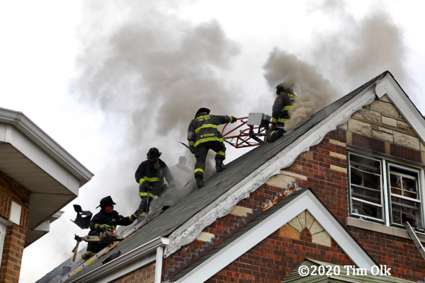 Firefighters own roof of house on fire
