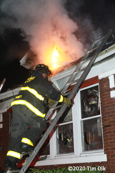 flames through roof of house on fire